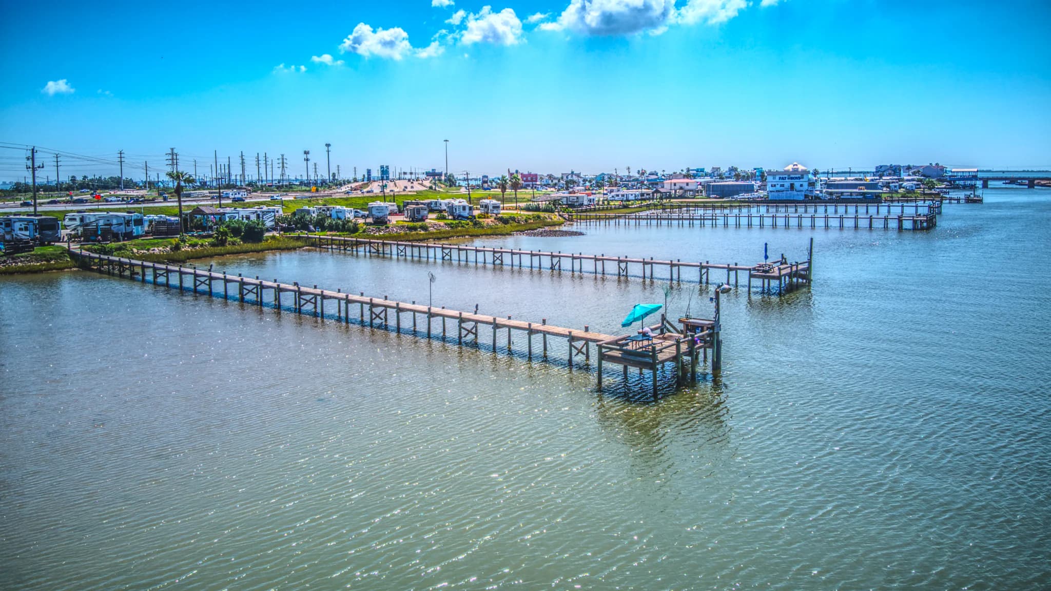 A current aerial view across the water shows long fishing piers and RV sites along Tiki Tom’s shoreline.